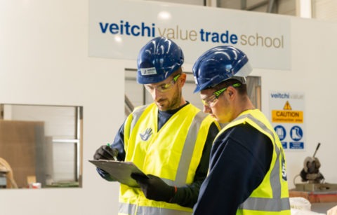 Two Veitchi Apprentices check clipboard in Veitchi Value Trade School