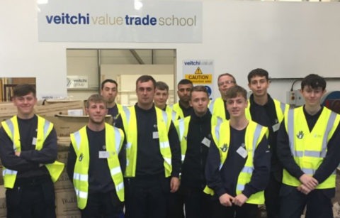 All Veitchi Apprentices posing in front of Veitchi Value Trade School sign