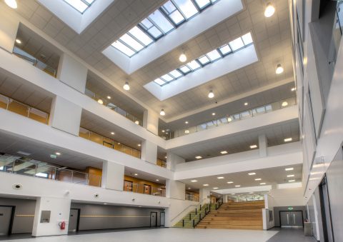 Large school hall with balconies overlooking on all sides and stairs in the far end