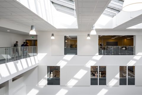 The top of the previously mentioned hall, with a balcony on the left and canteen visable through windows on the back wall